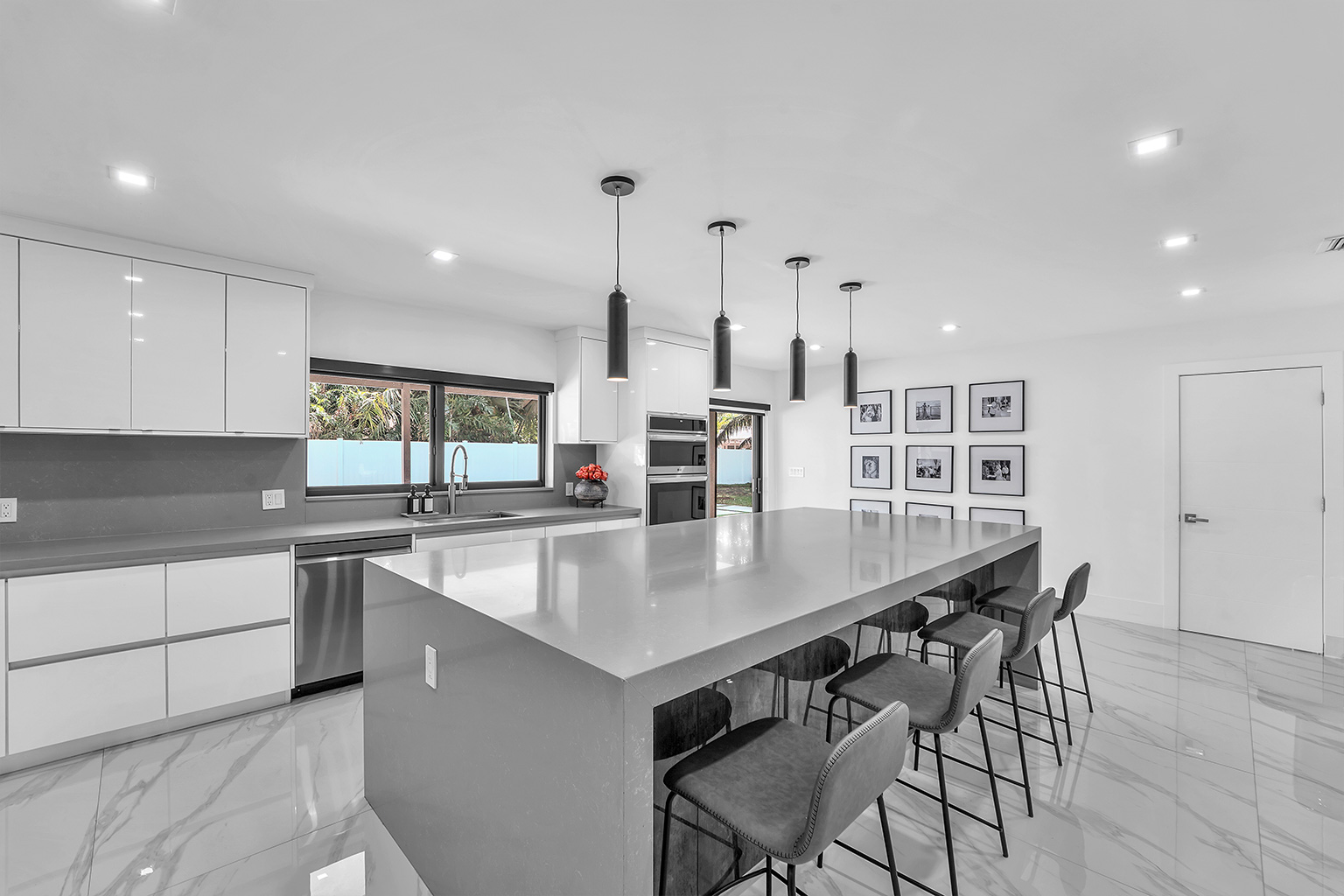 Kitchen island with bar seating and gallery wall