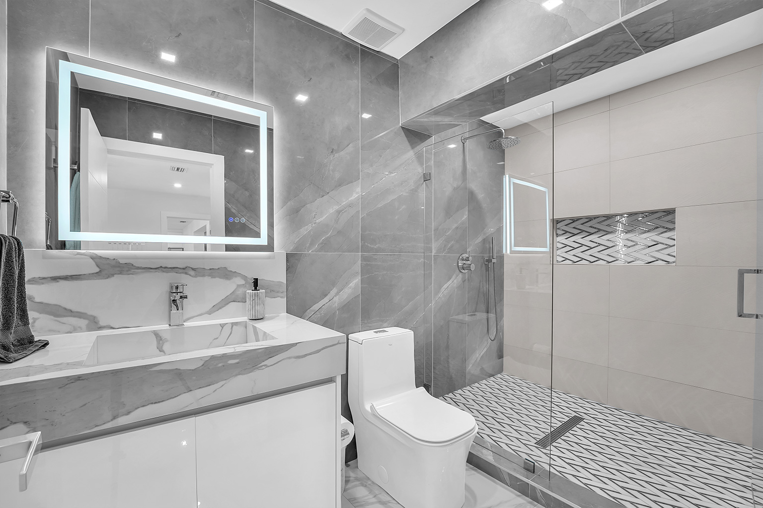 Modern bathroom with LED mirror and walk-in shower