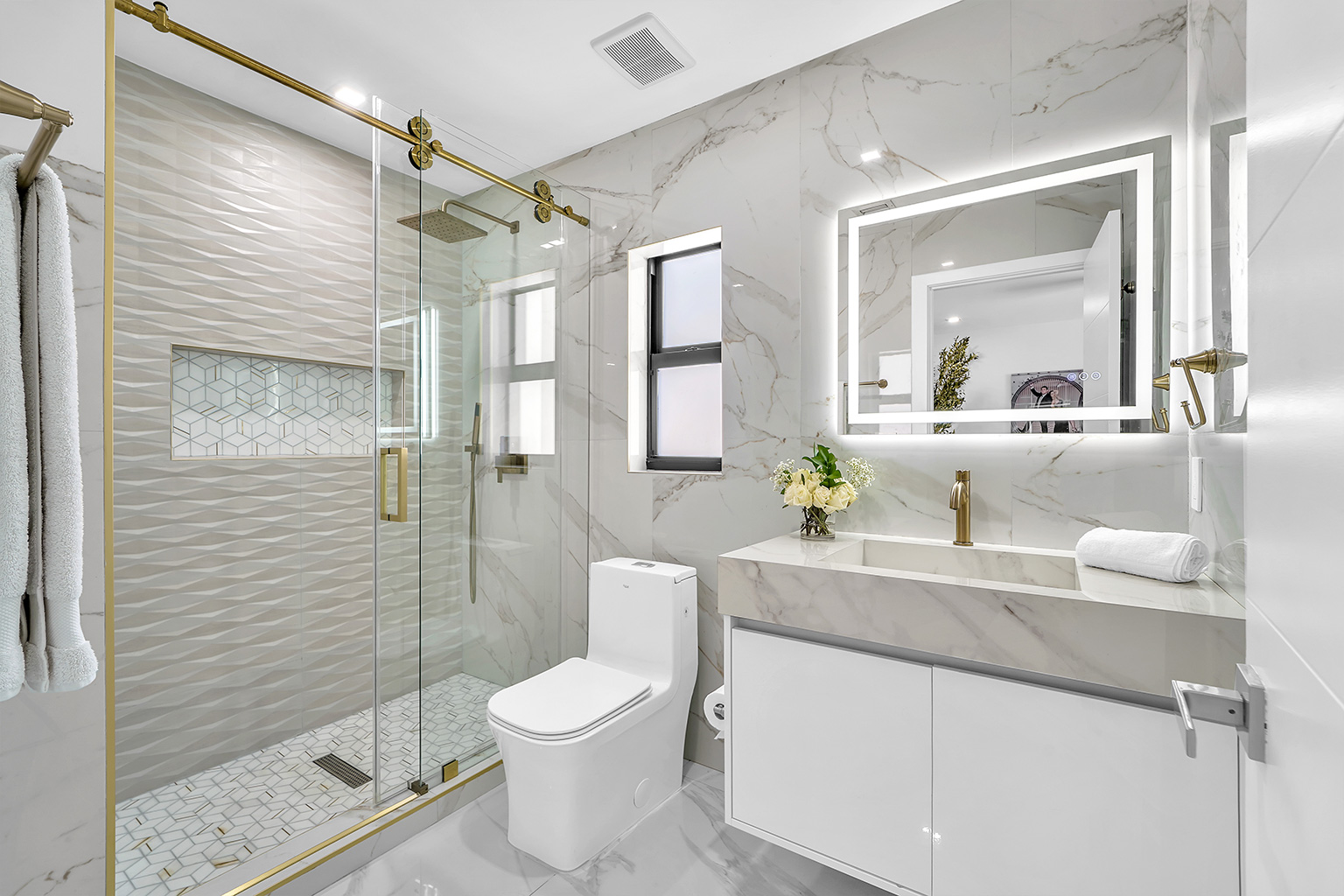 Spa bathroom with gold fixtures and marble