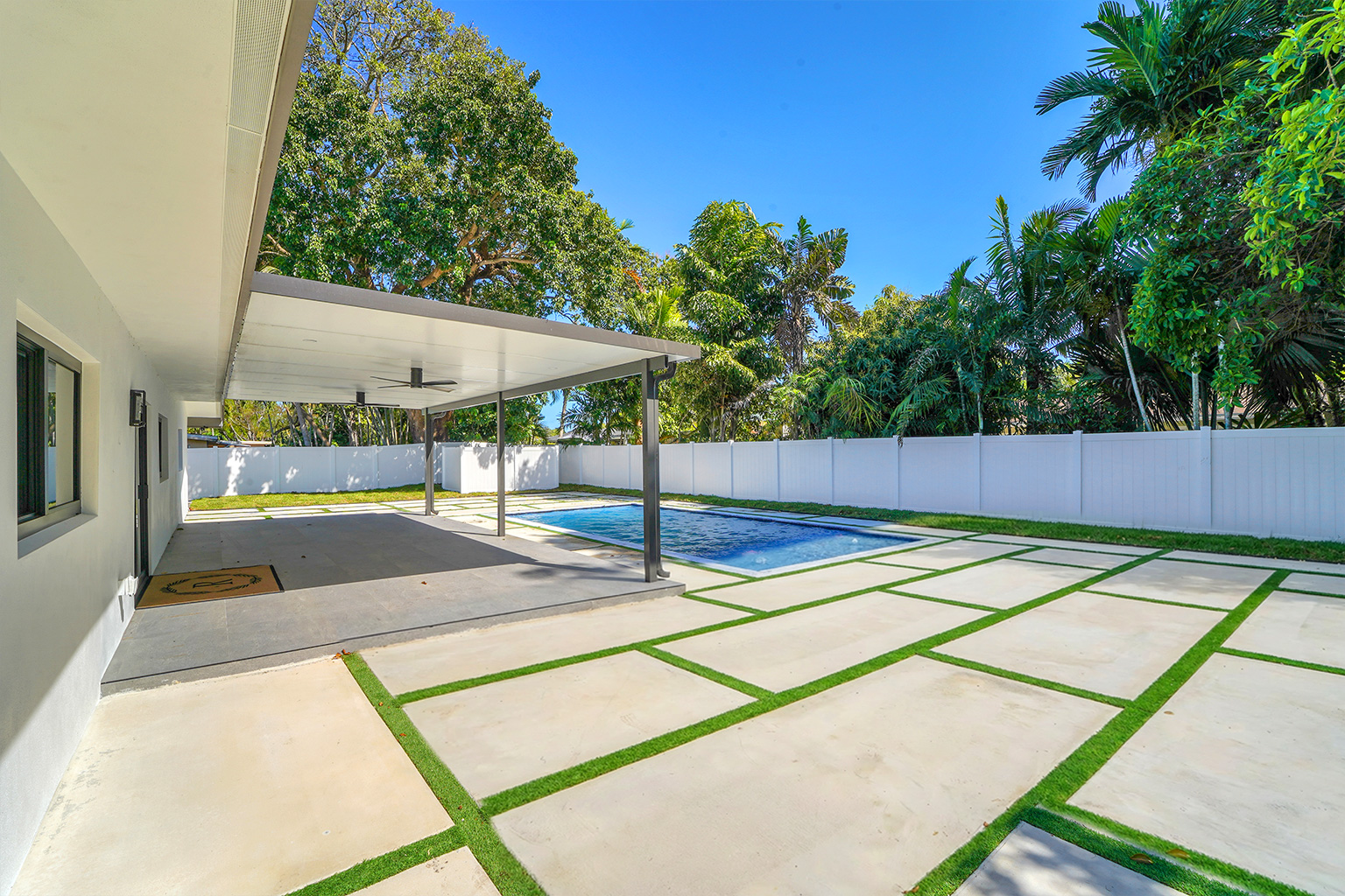 Pool with covered patio and grass pavers