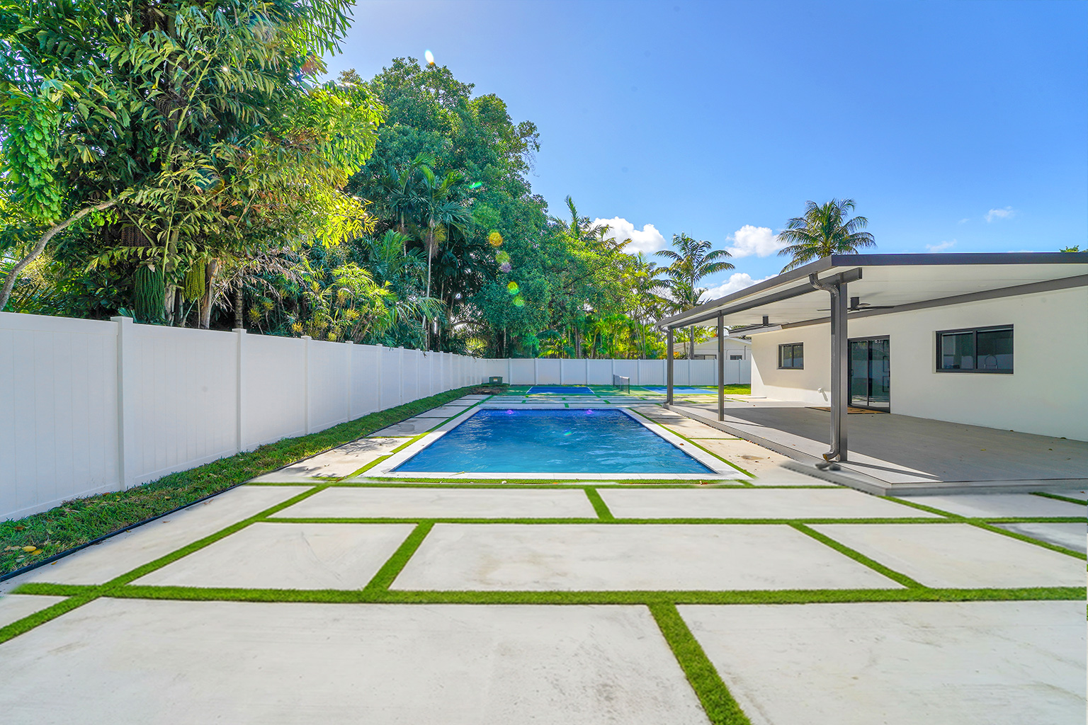 Heated saltwater pool with tropical landscaping